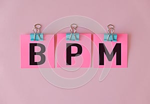 BPM text on a pink sticker and on pink background