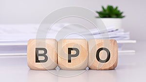 BPO text on wooden cubes on the gray background. Business Process Outsourcing concept