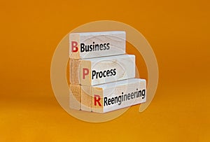 BPR business process reengineering symbol. Concept words BPR business process reengineering on blocks on beautiful orange