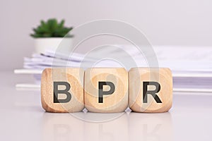 BPR & x27;Business Process Reengineering& x27; - text on wooden cubes on the gray background. business concept