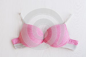 Bra pink sporty on white wooden background