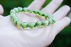 Bracelet from green beads on an elastic band. Decoration for girls. Women`s bracelet with an elastic band. Bracelet