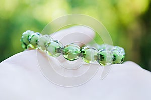 Bracelet from green beads on an elastic band. Decoration for girls. Women`s bracelet with an elastic band. Bracelet