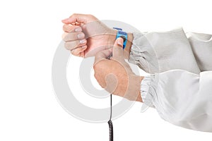 Bracelet on the hand of a man wearing ESD cloth isolated on whit photo