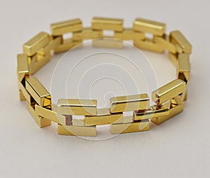 Bracelet made of gold bars on a white background close up