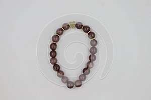 Bracelet made of natural stones on a white background.