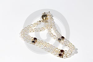 bracelet made of pearls, garnet and diamonds with a gold clasp. Yellow gold and precious stones