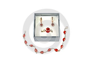 Bracelet, ring and earrings with garnet isolated on white