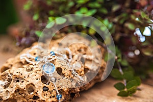 Bracelets made of natural stones on textured stones. The mysticism of amulets. Esoterics in handmade bracelets close-up and copy s