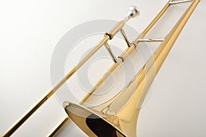 Braces and mouthpiece of a trombone on white table photo