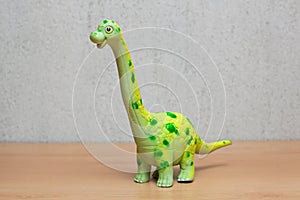 Brachiosaurus dinosaurs toy on wooden table.