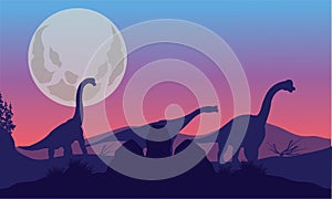 Brachiosaurus of silhouette with moon