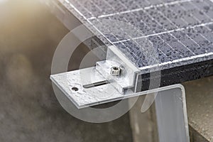 Bracket for mounting solar panels. Mounting a solar panel close-up on the roof of a residential building, water drops