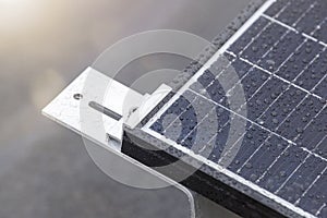 Bracket for mounting solar panels. Mounting a solar panel close-up on the roof of a residential building, water drops after rain,