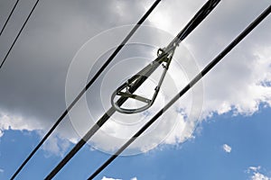 Bracket of a snowshoe bend limiter for fiber optics against a blue sky with clouds