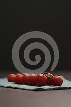 bracnh of fresh cherry tomatoes of wood table