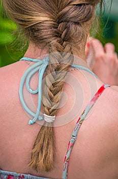 Braid of a young woman from the back