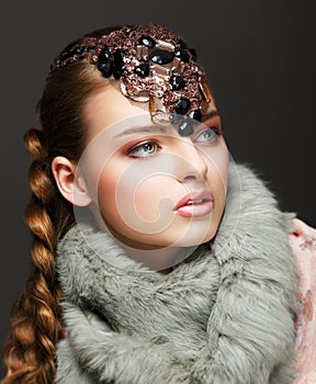 Braided Hair Luxurious Woman in Fur Collar and Gemstones. Jewels