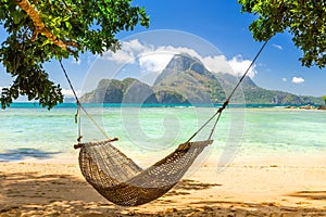 Braided hammock in the shade on a sunny tropical island