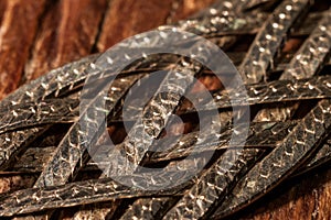 Braided metal strips with scales