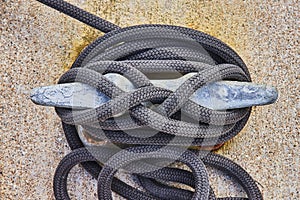 Braided Rope on Weathered Dock Cleat, Nautical Detail