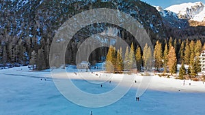 Braies Lake blotted in winter, aerial view from drone, Italian Alps