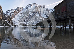 Braies lake and Dolomite with snow, palafitte harbor photo