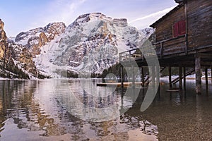 Braies lake and Dolomite with snow, quiet water and  palafitte harbor photo