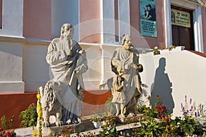 Figures of saints in churchyard before Catholic church Sanctuary of Jesus of Nazareth, old christian temple, Brailiv, Ukraine