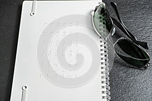Braille dots - reading without seeing.braille alphabet at the back of notebook