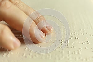 Braille reading. Blind man reads a book in braille