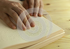 Braille reading. Blind woman reads a book in braille