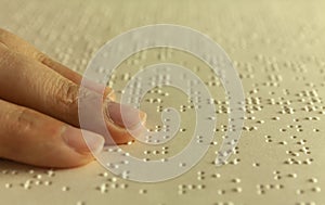 Braille reading. Blind woman reads a book in braille