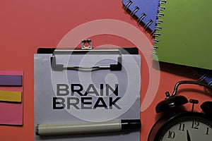 Brain Break write on paperwork. Isolated on pink table background