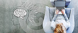 Brain illustration with man using a laptop