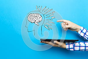 Brain illustration with a tablet computer