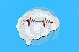 Brain Puzzle with Heart Rate Signal on Blue