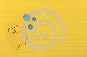 Brain works concept. Thinking, creativity concept of the human head with gears on yellow background