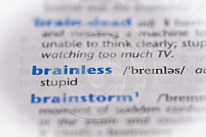 Brainless word in a dictionary. Selective focus, close up photo