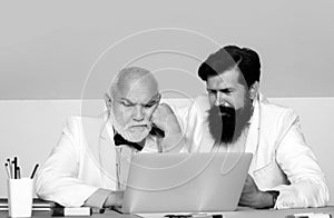 Brainstorming concept, Two businessmen thinking in office. Male coworkers working at workplace. Businessman using laptop