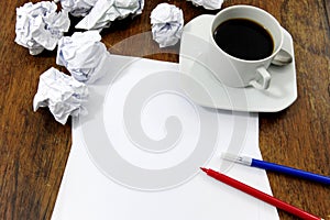 Brainstorming: paper on desk with paperballs