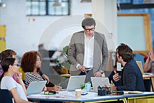 Brainstorming their way to success. business people around a table.