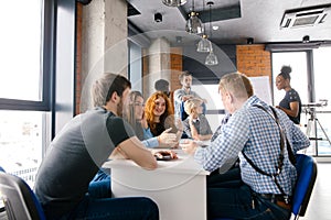 Brainstormng process of office workers sitting around the table