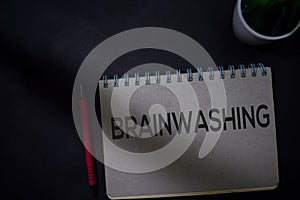 Brainwashing write on a book isolated on Office Desk