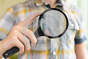 Brainy lad with magnifying glass