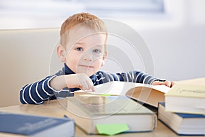 Brainy little boy learning at home