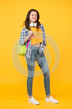 Brainy is new sexy. Happy student yellow background. University student carry backpack. Pretty student smile in casual