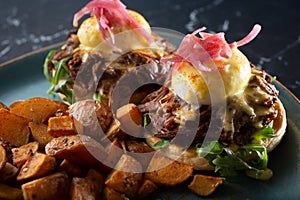 braised beef eggs Benedict plate
