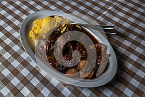 Braised beef with onion and corn polenta