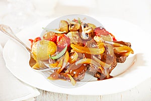 Braised beef with onion sauce and oven baked vegetables